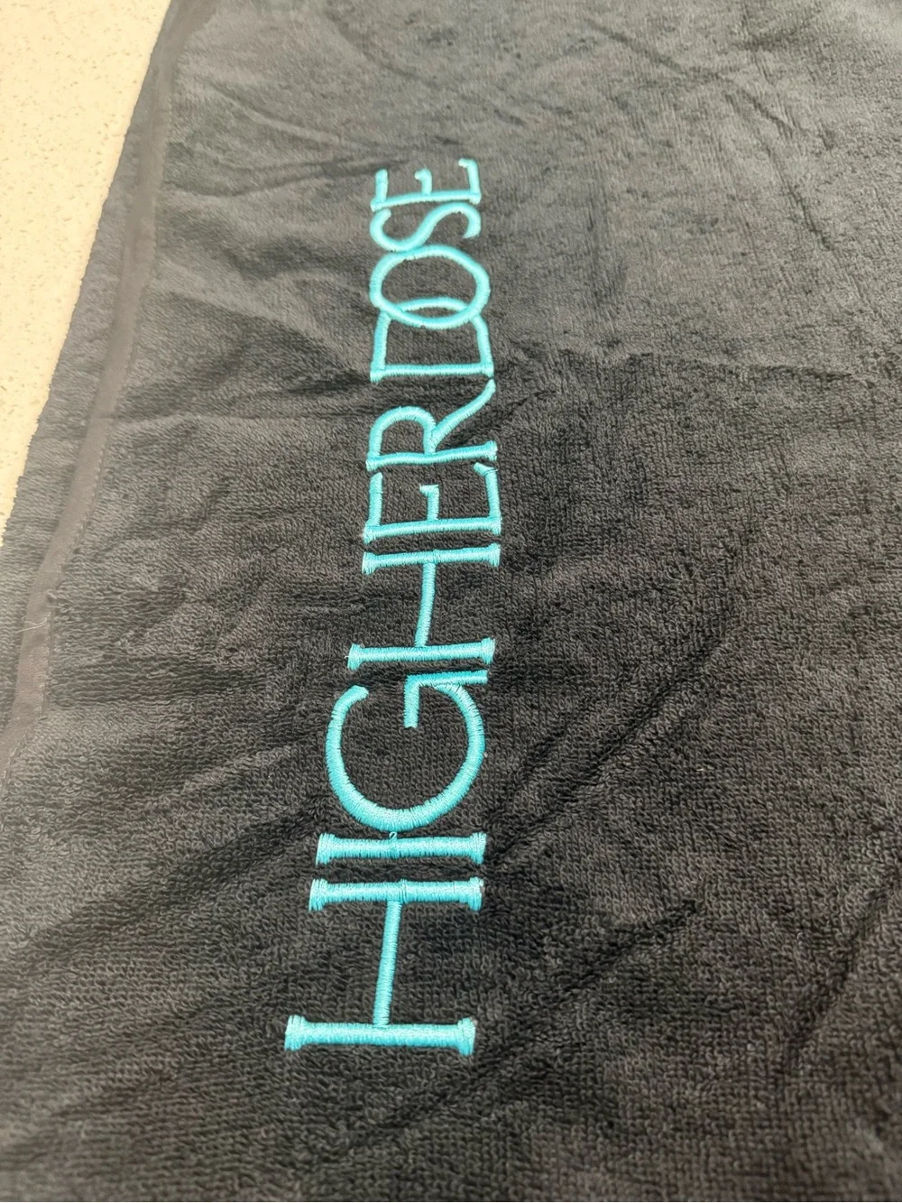 HIGHER DOSE Embroidered Black Bath Towel with Teal Logo